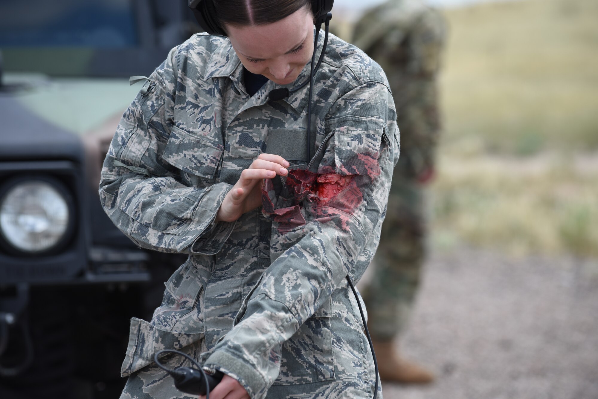 An Airman looks at her simulated wound after the conclusion of the 90th Mission Support Group’s Warrior Day at F.E. Warren Air Force Base, Wyoming, Aug. 15, 2019. The purpose of the training day was to provide 90th Force Support Squadron Airmen with convoy operations knowledge, allowing them to fulfill a supporting role. (U.S. Air Force photo by Senior Airman Abbigayle Williams)