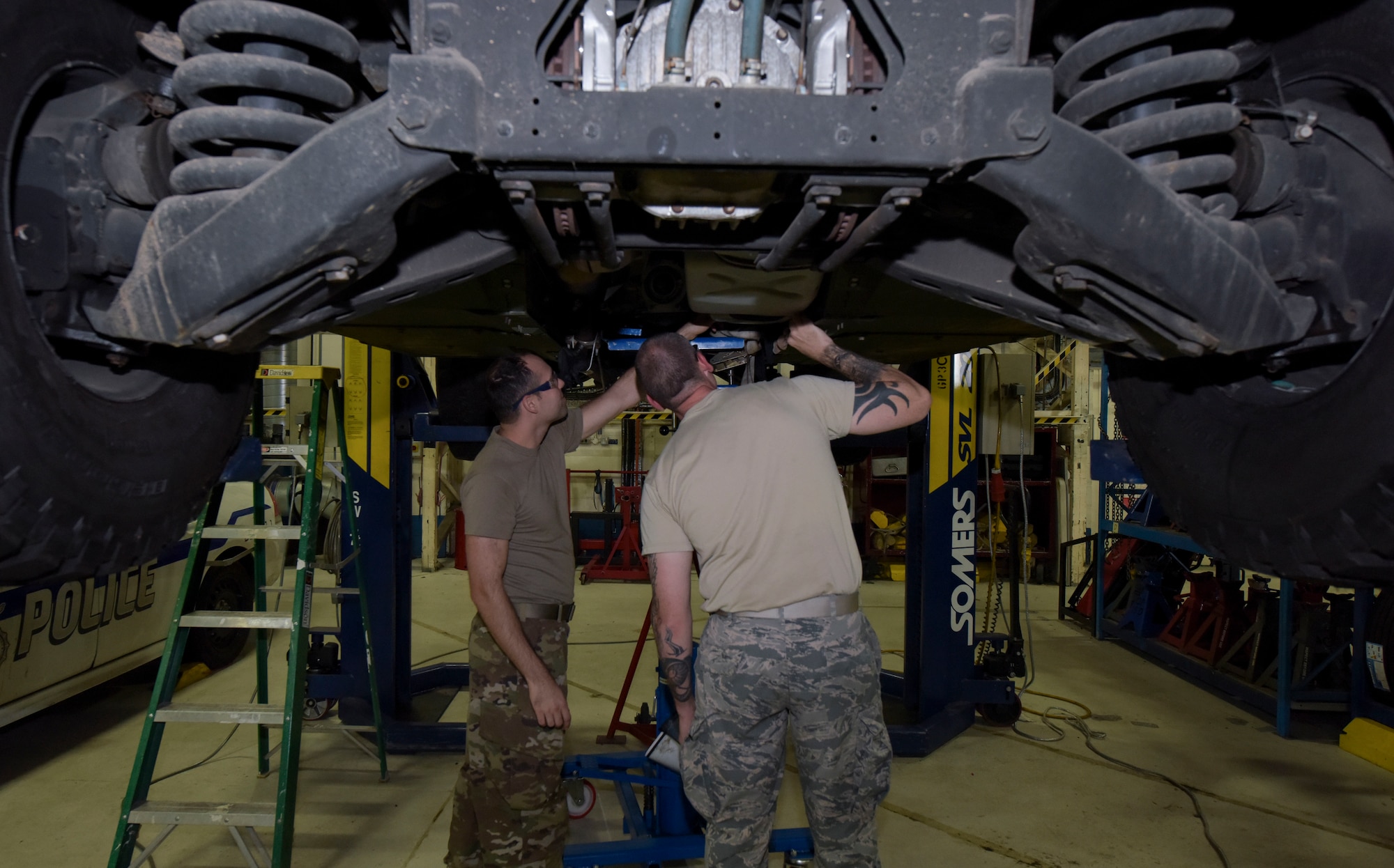 Texas Air National Guardsmen Airman 1st Class Ryan Doan, 221st Combat Communications Squadron vehicle mechanic, Naval Air Station Joint Reserve Base Fort Worth, Texas, left, and Master Sgt. Brandon Isam, 221st Combat Communications Squadron NCO-in-charge of vehicle maintenance, check the under carriage of a 100th Logistics Readiness Squadron assigned vehicle at RAF Mildenhall, England, July 30, 2019. The guardsmen conducted annual vehicle maintenance training with the 100 LRS here. (U.S. Air Force photo by Senior Airman Alexandria Lee)