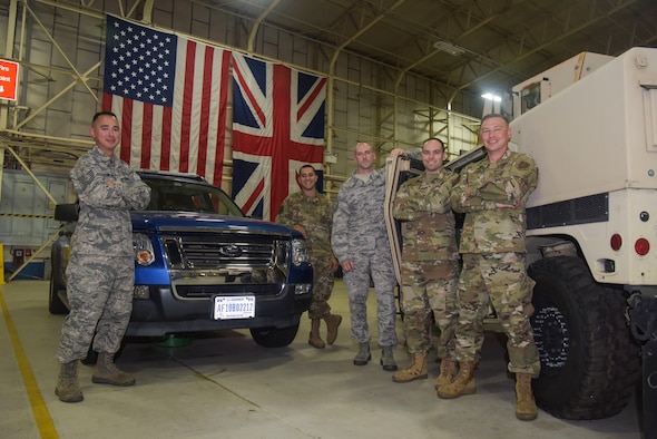 Members of the 136th Logistics Readiness Squadron, Texas Air National Guard, pose for a photo at RAF Mildenhall, England, July 30, 2019. The guardsmen conducted annual vehicle maintenance training with the 100th Logistics Readiness Squadron. (U.S. Air Force photo by Senior Airman Alexandria Lee)