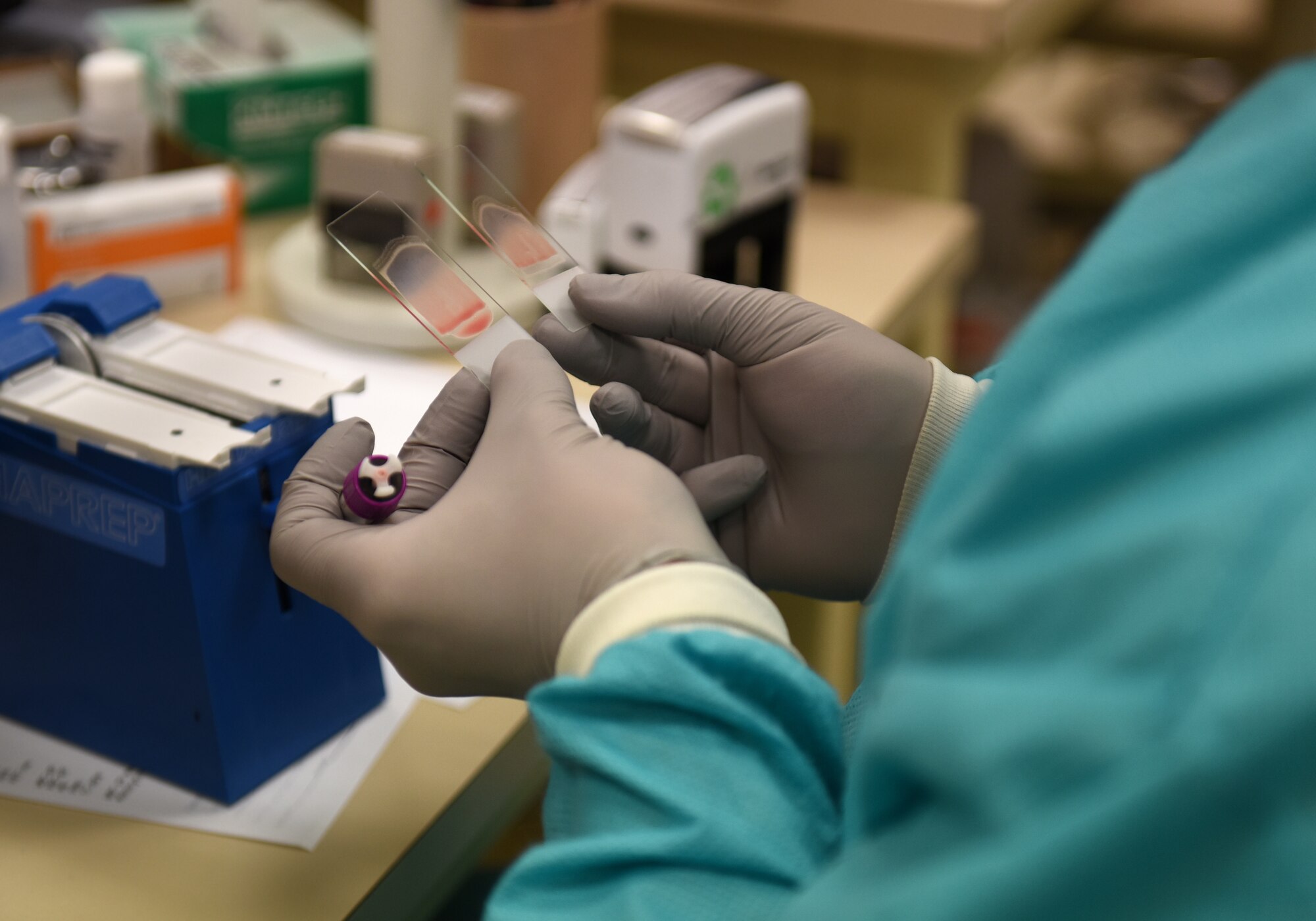 A 48th Medical Support Squadron laboratory technician looks at slides at Royal Air Force Lakenheath, England, Aug.14, 2019. Laboratory technicians at the 48th Fighter Wing have an integral role in providing Airmen and their family members with a proper diagnosis and treatment to support the readiness mission. (U.S. Air Force photo by Airman 1st Class Madeline Herzog)