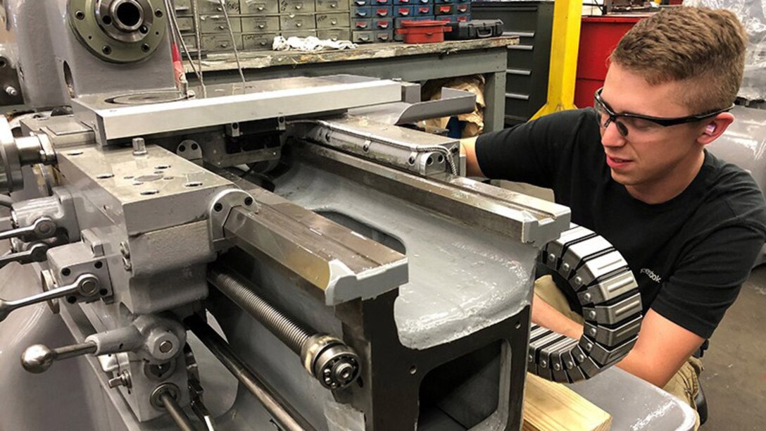 Production Machinery Mechanic Kristopher Nace refurbishes a Monarch EE Lathe