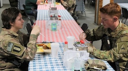 Spc. Kelsey Harty, a paralegal specialist with the 398th Support Battalion, 1st Infantry Division Sustainment Brigade, has lunch with her brother Spc. James Harty, a CH-47 Chinook helicopter repairer with the 2d Battalion, 501st Aviation Regiment, 1st Armored Division, at Bagram Air Field, Afghanistan, May 1, 2019. The brother and sister spent time together before James' promotion ceremony from the rank of specialist to sergeant.