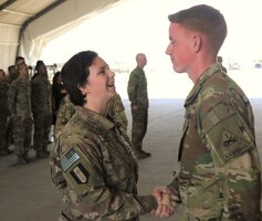 Spc. Kelsey Harty, a paralegal specialist with the 398th Support Battalion, 1st Infantry Division Sustainment Brigade, congratulates Sgt. James Harty, a CH-47 Chinook helicopter repairer with the 2d Battalion, 501st Aviation Regiment, 1st Armored Division, after his promotion to sergeant at Bagram Air Field, Afghanistan, May 1, 2019. Due to the two being deployed in the same location, Kelsey was able to participate in James' promotion ceremony.