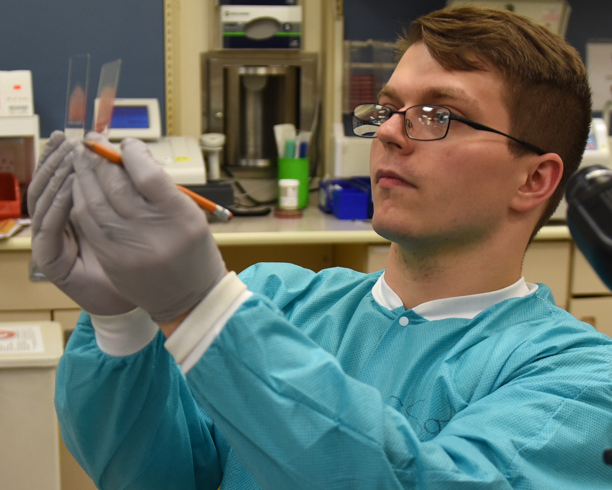 A 48th Medical Support Squadron laboratory technician compares slides at Royal Air Force Lakenheath, England, Aug.14, 2019. Laboratory technicians provide accurate medical tests and appropriately diagnose illnesses to ensure the readiness of Liberty Wing Airmen. (U.S. Air Force photo by Airman 1st Class Madeline Herzog)