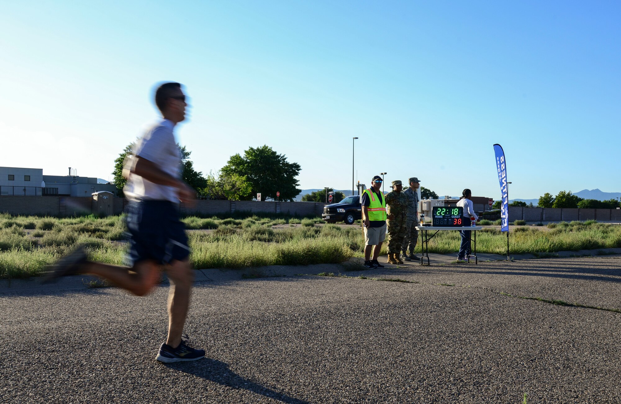 A member of the 377th Air Base Wing crosses the finish line during a Wing Tiger Run at Kirtland Air Force Base, N.M., August 16, 2019.  The Tiger Run is an opportunity for Airmen to display how Physical Fitness is one of the four pillars of Comprehensive Airman Fitness. (U.S. Air Force Photo by Airman 1st Class Kiana Pearson)