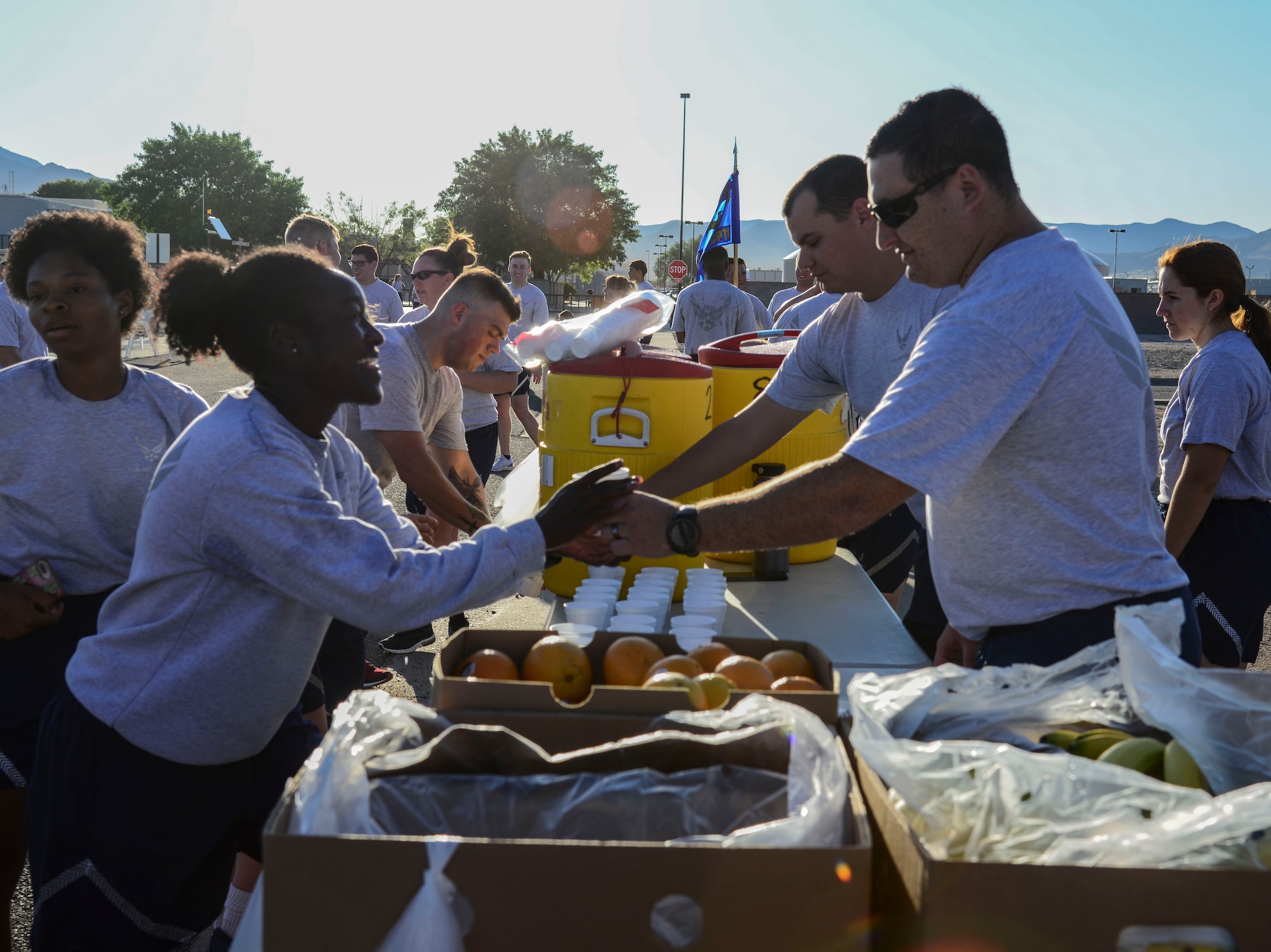 Volunteers hand out water to participants after they complete a Wing Tiger Run at Kirtland Air Force Base, N.M., August 16, 2019.  The Tiger Run is 5-kilometers long and is held quarterly to bring different units of the 377th Air Base Wing together to increase morale and esprit de corps. (U.S. Air Force Photo by Airman 1st Class Kiana Pearson)