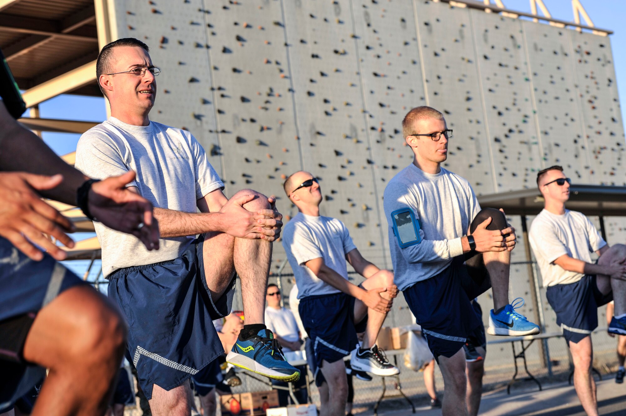 Members of the 377th Air Base Wing stretch to prepare for a Wing Tiger Run at Kirtland Air Force Base, N.M., August 16, 2019.  Wing Tiger Runs are held quarterly to bring different units of the 377th ABW together to increase morale and esprit de corps (U.S. Air Force Photo by Senior Airman Enrique Barcelo).