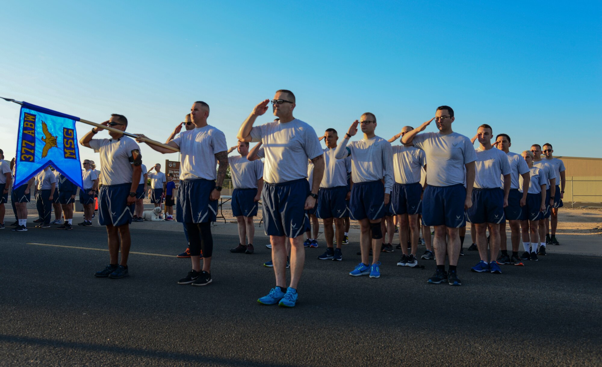 Members of 377th Mission Support Group stand in formation during revile before a Wing Tiger Run at Kirtland Air Force Base, N.M., August 16, 2019.  Wing Tiger Runs are held quarterly to bring different units of the 377th Air Base Wing together to increase morale and esprit de corps. (U.S. Air Force Photo by Airman 1st Class Kiana Pearson)