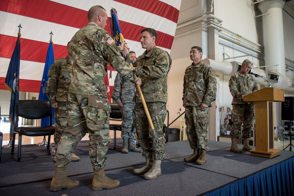 Brig. Gen. Jeffrey Wilkinson (center) assumes responsibility as Kentucky’s next assistant adjutant general for Air as he receives the Headquarters, Kentucky Air National Guard guidon from U.S. Army Maj. Gen. Stephen Hogan, Kentucky’s adjutant general, during a ceremony at the Kentucky Air National Guard Base in Louisville, Ky., Aug. 11, 2019. Wilkinson replaces Brig. Gen. Warren Hurst, who held the post for six years. (U.S. Air National Guard photo by Staff Sgt. Joshua Horton)