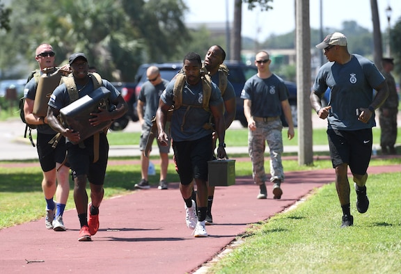 Members of the 81st Security Forces Squadron participate in the ammo carry portion of the 81st SFS Defender's Challenge Ruck on the Crotwell Track on Keesler Air Force Base, Mississippi, Aug. 16, 2019. The competition, consisting of 11 four-person teams, completing seven obstacles, was one of several events in recognition of The Year of the Defender. (U.S. Air Force photo by Kemberly Groue)