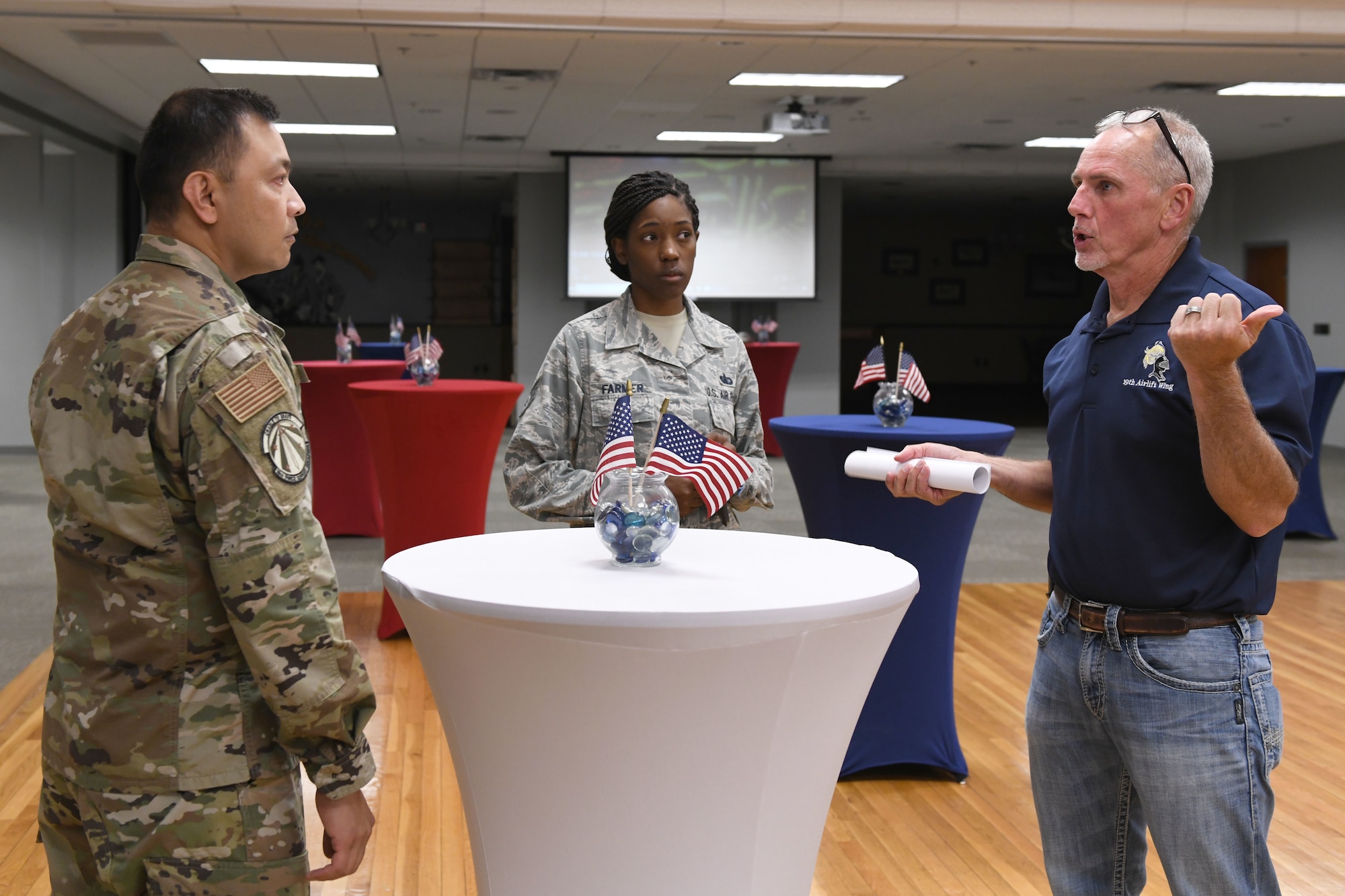 a man talks to two airmen