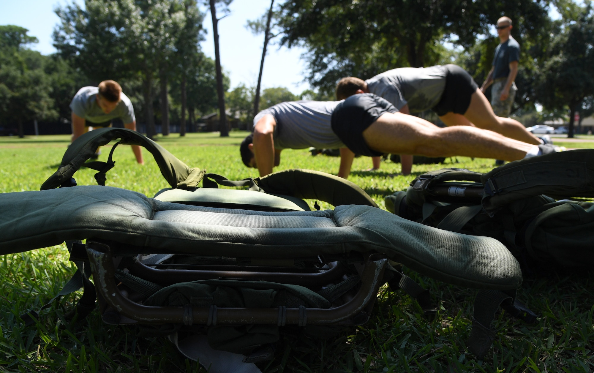 Ruck sacks are displayed on the ground during the 81st Security Forces Squadron Defender's Challenge Ruck near the Crotwell Track on Keesler Air Force Base, Mississippi, Aug. 16, 2019. The competition, consisting of 11 four-person teams, completing seven obstacles, was one of several events in recognition of The Year of the Defender. (U.S. Air Force photo by Kemberly Groue)