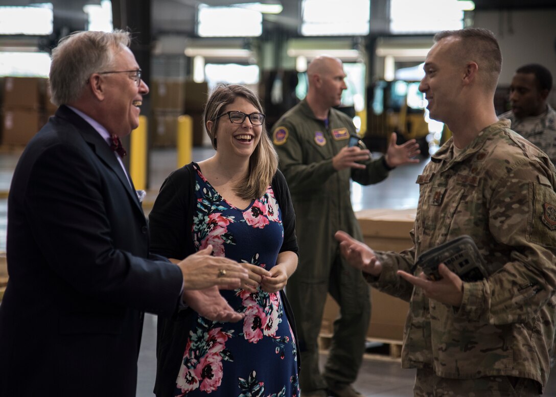 Christopher Cooper, branch head for Naval Sea Systems Command, and Jandi Potts, foreign military sales case manager, share a laugh with Capt. Michael McFadden, operations officer, August 16, 2019, at Dover Air Force Base, Delo. Cooper and Potts visited Dover AFB to praise the Airmen who participated in the joint mission of delivering a torpedo to India. (US Air Force Photo by Airman 1st Class Jonathan Harding)