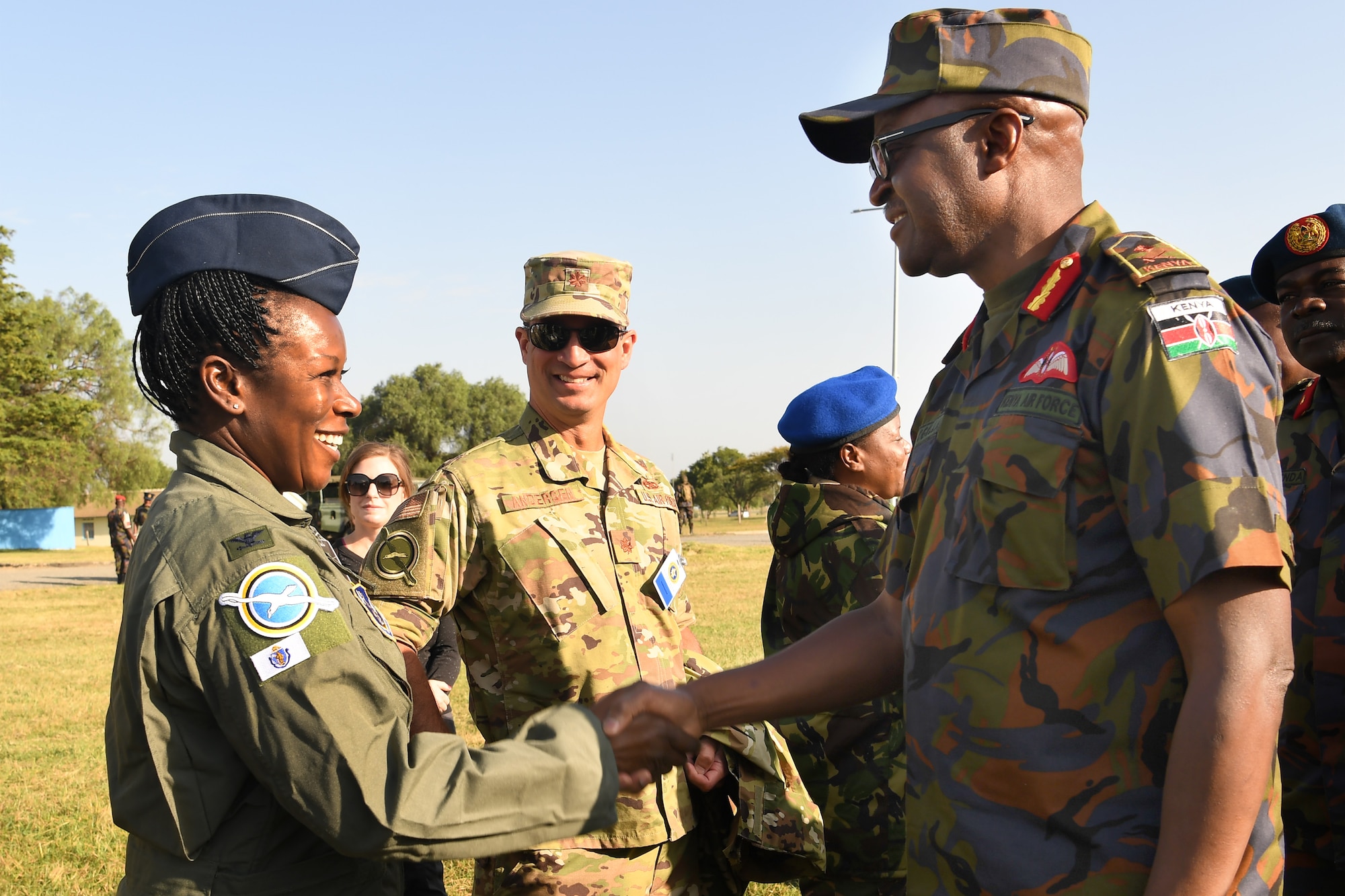 Col. Melinda Swanson, 102nd Medical Group commander, shakes hands with Maj. Gen. Francis C. Ogolla, commander of the Kenya air force, following the opening ceremony for African Partnership Flight Kenya 2019 at Laikipia Air Base, Kenya, August 20, 2019.