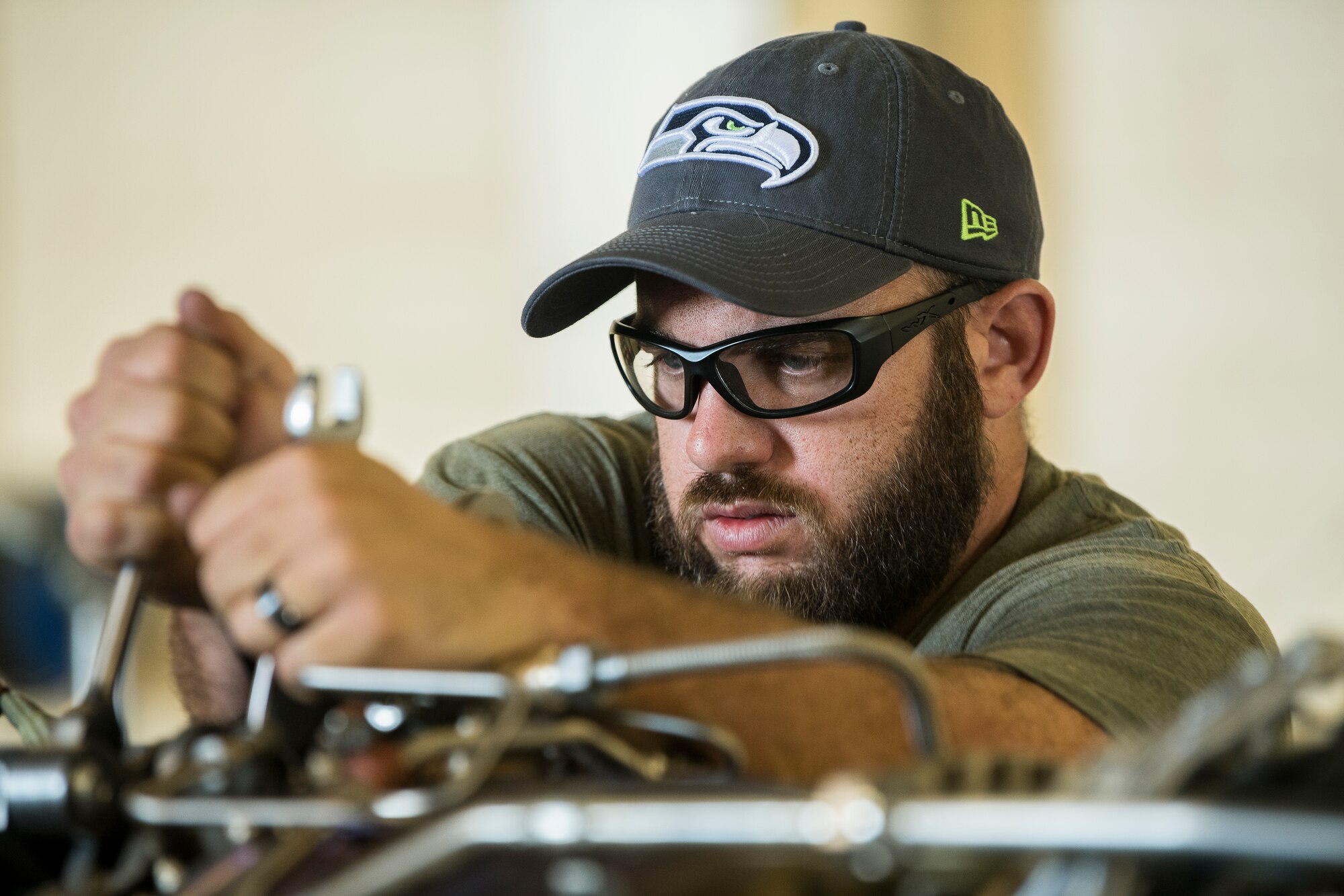 Luke McSweeney, 727th Special Operations Air Maintenance Squadron contract maintainer, tightens a bolt on a CV-22 Osprey engine at Cannon Air Force Base, N.M, Aug. 13, 2019. The process of replacing the engine took the team of three 25 minutes. (U.S. Air Force Photo by Senior Airman Vernon R. Walter III)