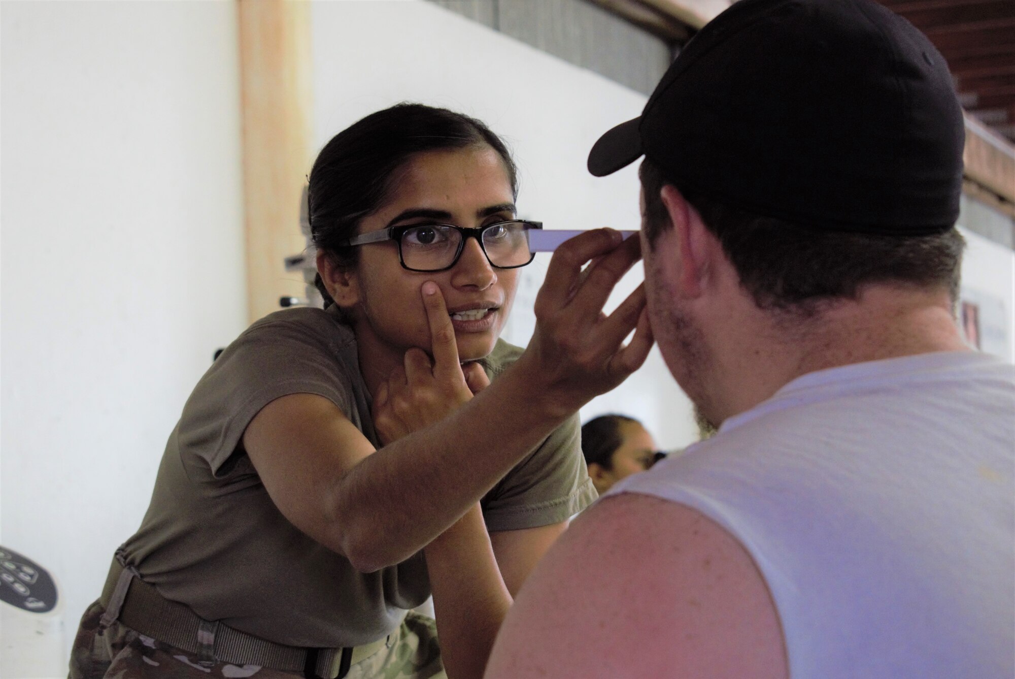 U.S. Army Capt. Sadia Kalsoom, optometrist, Expeditionary Medical Facility Dallas One, Ft. Worth, Texas, examines a patient at Innovative Readiness Training Appalachian Care 2019 at Wise County Fairgrounds, Wise, Va., Aug. 18, 2019. Appalachian Care Innovative Readiness Training 2019 takes place Aug. 16-29, 2019, to care for the medically underserved communities of Wise, Virginia while simultaneously conducting deployment and readiness training for military personnel. Innovative Readiness Training is the only hands-on training opportunity authorized to operate within the U.S. During Appalachian Care IRT 2019, medical operations will be staged at one physical location at Wise County Fairgrounds. The Appalachian Care IRT 2019 team provides medical, dental, optometry and veterinary care to assist local health and municipal authorities in addressing underserved and unmet community health and civic needs. Units also conduct critical mission training and logistical movement in order to simulate hands-on deployment readiness operations and health care delivery in the time of crisis, conflict or disaster. (Air National Guard photo by 1st Lt. Andrew Layton)