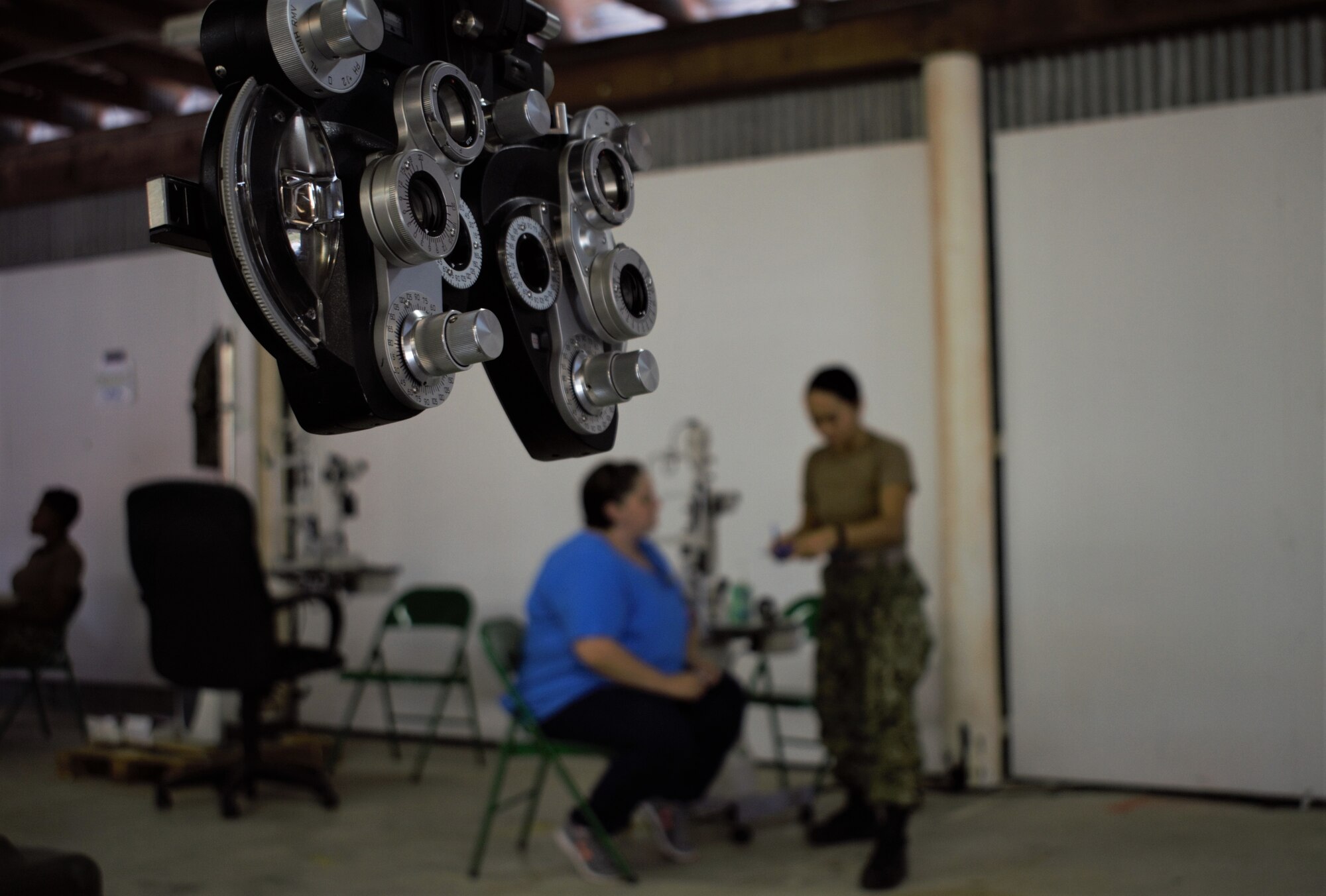 U.S. Navy Reserve Lt. Gillian Claveria-Oooms, optometrist, Expeditionary Medical Facility Dallas One, Ft. Worth, Texas, examines a patient at Innovative Readiness Training Appalachian Care 2019 at Wise County Fairgrounds, Wise, Va., Aug. 18, 2019. Appalachian Care Innovative Readiness Training 2019 takes place Aug. 16-29, 2019, to care for the medically underserved communities of Wise, Virginia while simultaneously conducting deployment and readiness training for military personnel. Innovative Readiness Training is the only hands-on training opportunity authorized to operate within the U.S. During Appalachian Care IRT 2019, medical operations will be staged at one physical location at Wise County Fairgrounds. The Appalachian Care IRT 2019 team provides medical, dental, optometry and veterinary care to assist local health and municipal authorities in addressing underserved and unmet community health and civic needs. Units also conduct critical mission training and logistical movement in order to simulate hands-on deployment readiness operations and health care delivery in the time of crisis, conflict or disaster. (Air National Guard photo by 1st Lt. Andrew Layton)