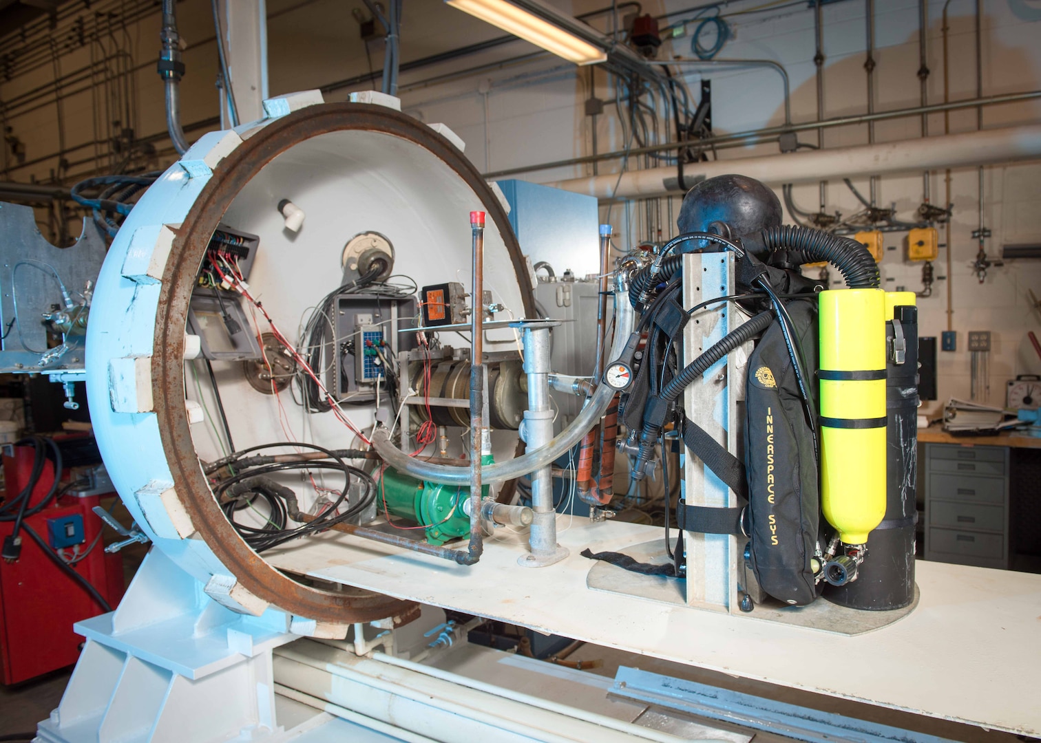 A testing manikin with a breathing system is placed into the chamber. Multiple sensors are embedded within the manikin head to simulate a manned system. Sensors are capable of measuring pressure, concentrations of carbon dioxide and oxygen, and temperature used in testing diving and other safety equipment.