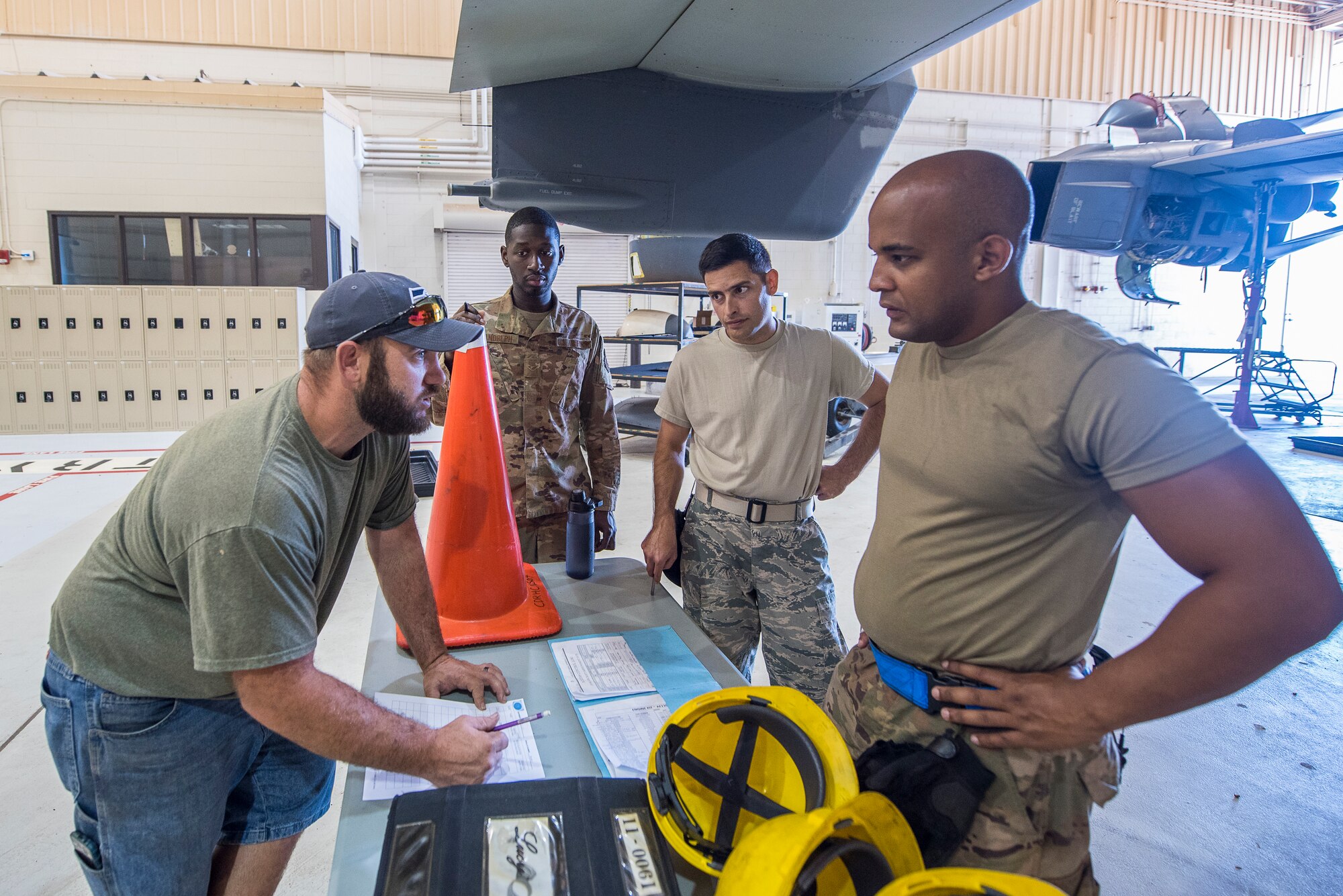 Members of the 727th Special Operations Aircraft Maintenance Squadron go over the task list to hoist an engine into a CV-22 Osprey at Cannon Air Force Base, N.M, Aug. 13, 2019. The process of replacing the engine took the team of three 25 minutes. (U.S. Air Force Photo by Senior Airman Vernon R. Walter III)