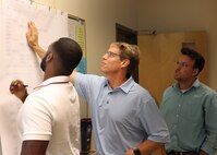 Participants of the Critical Path Method reviews planning charts.