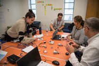 From left: Haley Kirby, a STEM and outreach specialist; Joel Luehr, an engineer in the Signatures Characterization and Analysis Division; Sylvia Rivera, the chief engineer for the Platforms Integrity Department; and Lou Carl, chief engineer for Naval Surface Warfare Center, Carderock Division, work as a team to design and build a Lego car during the Defense Acquisition University (DAU) Engineering Management Workshop on Aug. 15, 2019, at Carderock’s West Bethesda, Md., site. (U.S. Navy photo by Ryan Hanyok/Released)
