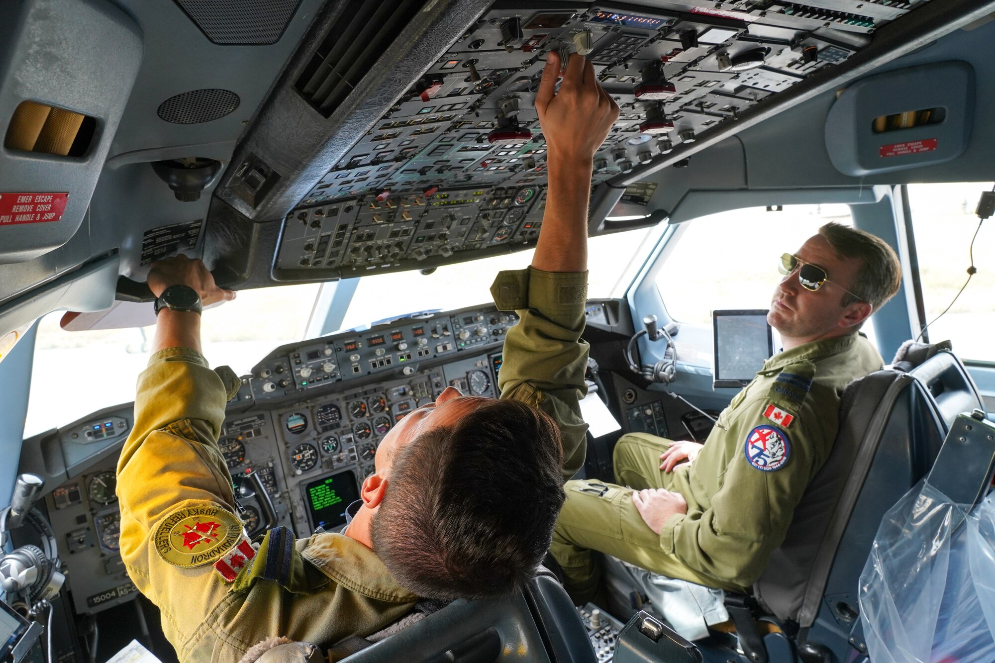 Royal Canadian Air Force pilots Capt. Russ Baker, left, and Capt. Andrew Williams, both assigned to the 437th Transport Squadron based out of Canadian Forces Base Trenton, Canada, perform pre-flight checks before refueling operations in training airspace over Alaska during the Red Flag-Alaska 19-3 exercise, Aug. 15, 2019. Red Flag-Alaska, a series of Pacific Air Forces commander-directed field training exercises for U.S. forces, provides joint offensive counter-air, interdiction, close air support, and large force employment training in a simulated combat environment.