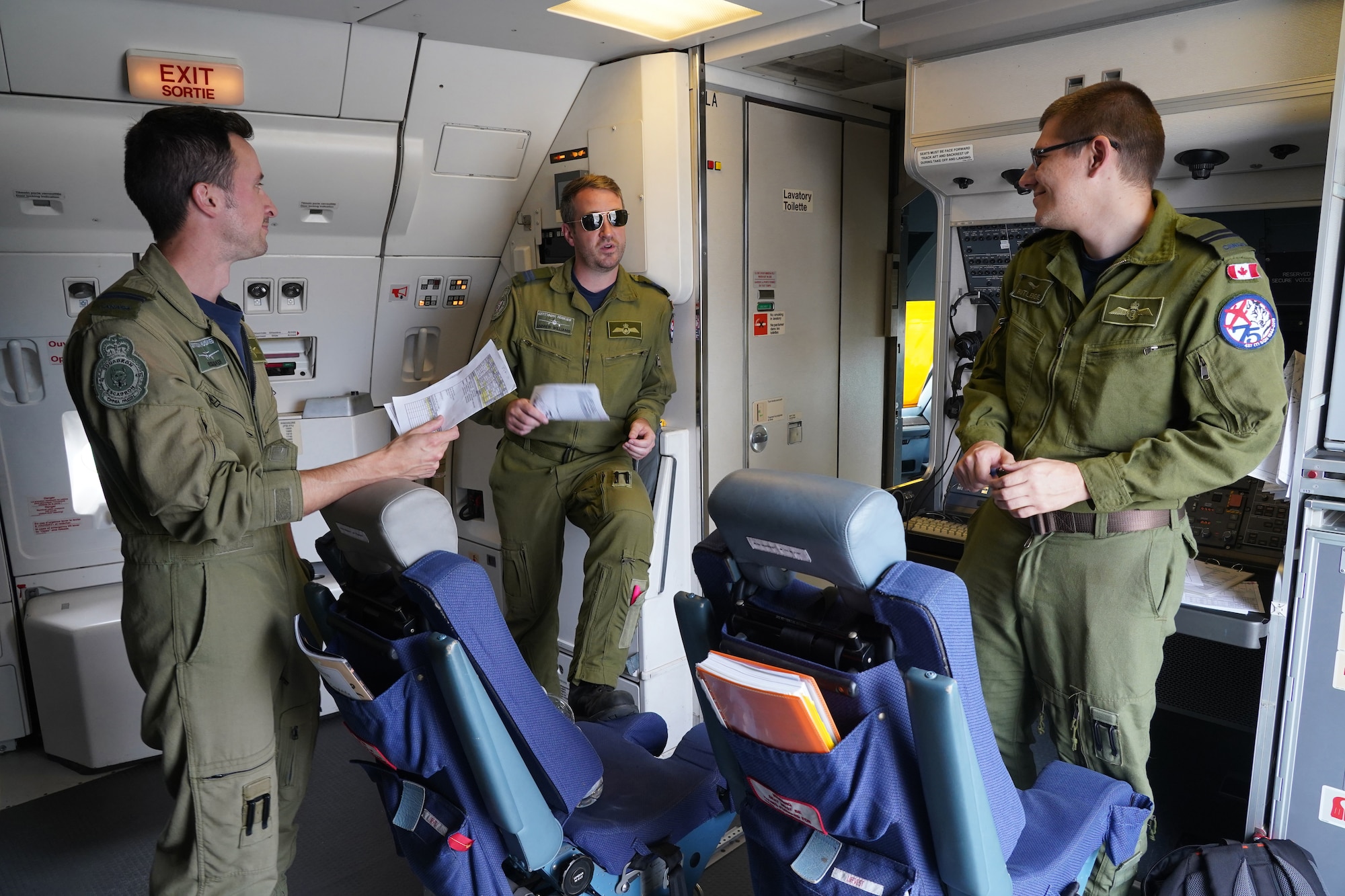 Royal Canadian Air Force captains Russ Baker, left, Andrew Williams, and Adam Rutledge, all assigned to the 437th Transport Squadron based out of Canadian Forces Base Trenton, Canada, conduct a pre-flight briefing aboard their CC-150 Polaris refueling tanker before refueling operations in training airspace over Alaska during the Red Flag-Alaska 19-3 exercise, Aug. 15, 2019. Red Flag-Alaska, a series of Pacific Air Forces commander-directed field training exercises for U.S. forces, provides joint offensive counter-air, interdiction, close air support, and large force employment training in a simulated combat environment.