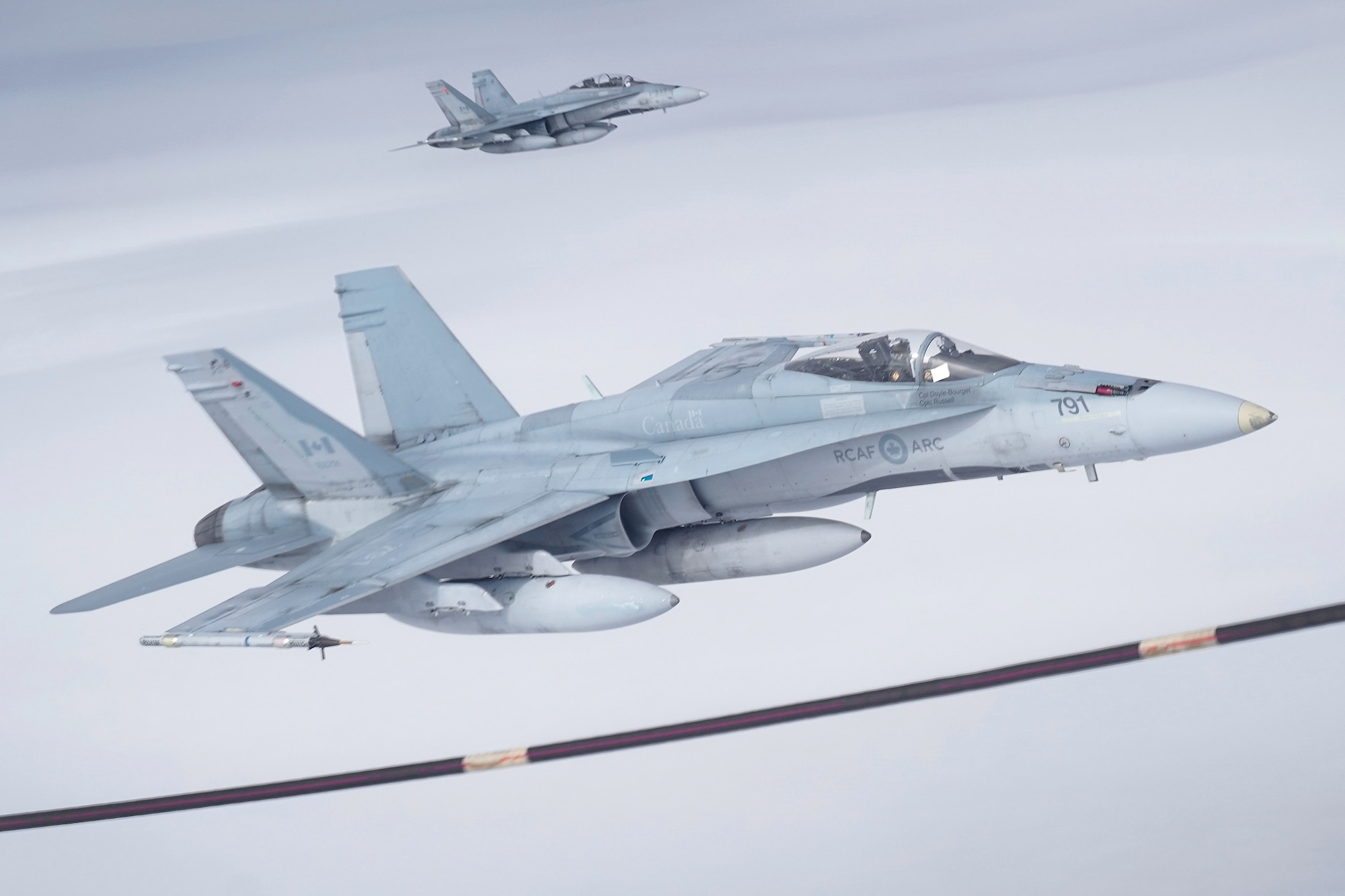 Two Royal Canadian Air Force CF-18 Hornets pull up to a CC-150 Polaris refueling tanker as RCAF Airmen assigned to the 437th Transport Squadron based out of Canadian Forces Base Trenton, Canada, perform refueling operations in training airspace over Alaska during the Red Flag-Alaska 19-3 exercise, Aug. 15, 2019. Red Flag-Alaska, a series of Pacific Air Forces commander-directed field training exercises for U.S. forces, provides joint offensive counter-air, interdiction, close air support, and large force employment training in a simulated combat environment.