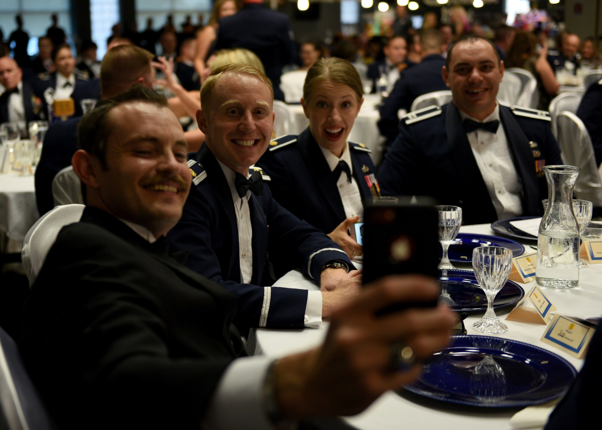 Guests of the Senior Noncommissioned Officer Induction Ceremony take photos together at the event center on Goodfellow Air Force Base, Texas, August 16, 2019. The event celebrated the Senior NCO inductees, and included a medallion ceremony, presentation of certificates, a guest speaker, and dinner. (U.S. Air Force photo by Airman 1st Class Robyn Hunsinger/Released)