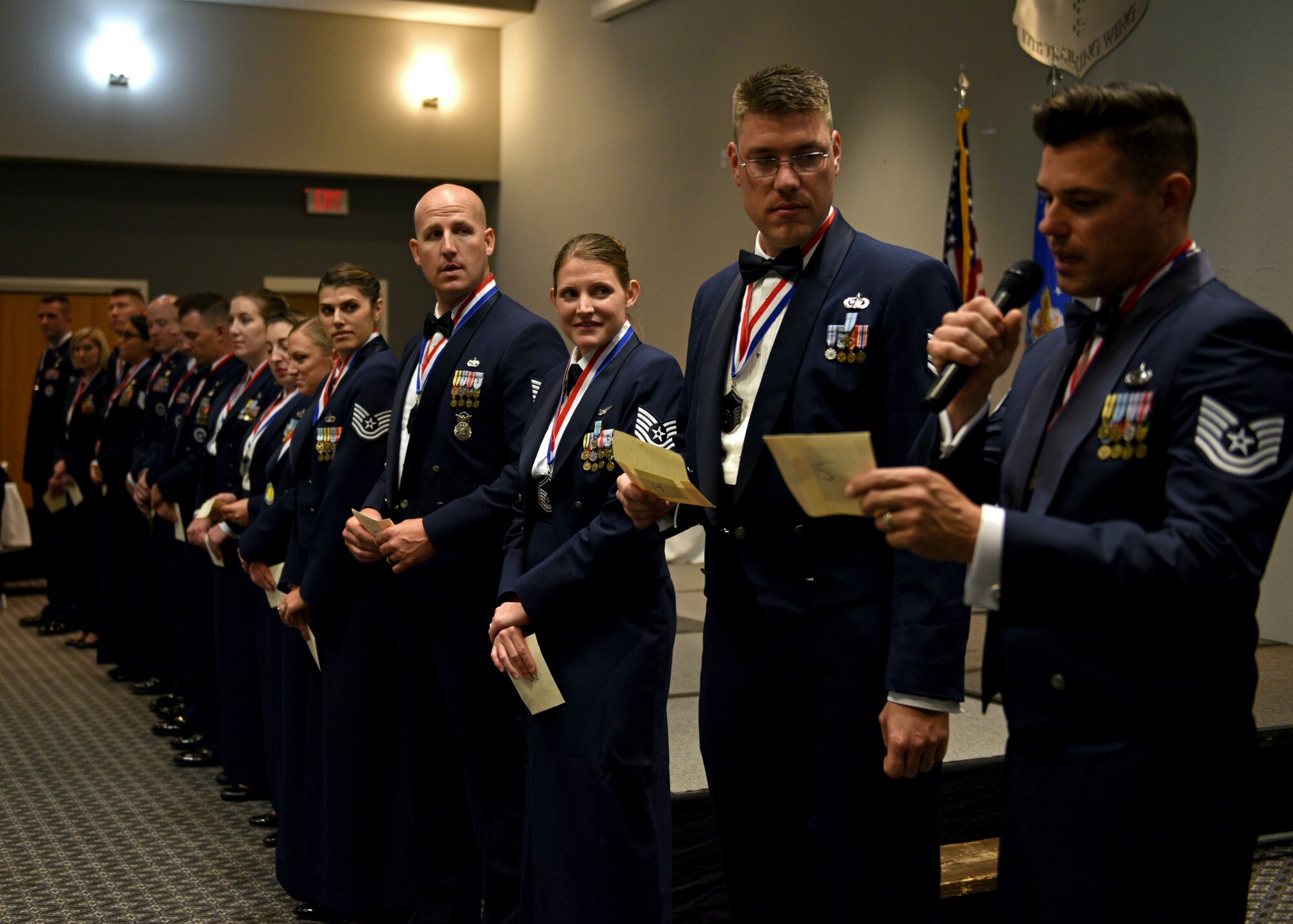 U.S. Air Force Senior noncommissioned officer inductees read out comment cards written by junior enlisted Airmen about what they expect from leadership during the Senior Noncommissioned Officer Induction Ceremony at the event center on Goodfellow Air Force Base, Texas, August 16, 2019. The inductees were asked to read these cards to further explain why it is important to ask junior Airmen for feedback. (U.S. Air Force photo by Airman 1st Class Robyn Hunsinger/Released)