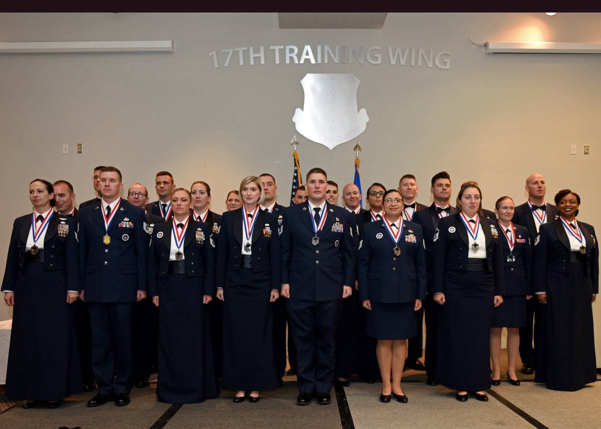 U.S. Air Force Senior noncommissioned officer inductees take on the Senior NCO charge during the Senior Noncommissioned Officer Induction Ceremony at the event center on Goodfellow Air Force Base, Texas, August 16, 2019. The inductees are transitioning from being technical experts and first line supervisors to operational leaders skilled in merging subordinates’ talents, skills, and resources with other teams’ functions to most effectively accomplish the mission. (U.S. Air Force photo by Airman 1st Class Robyn Hunsinger/Released)