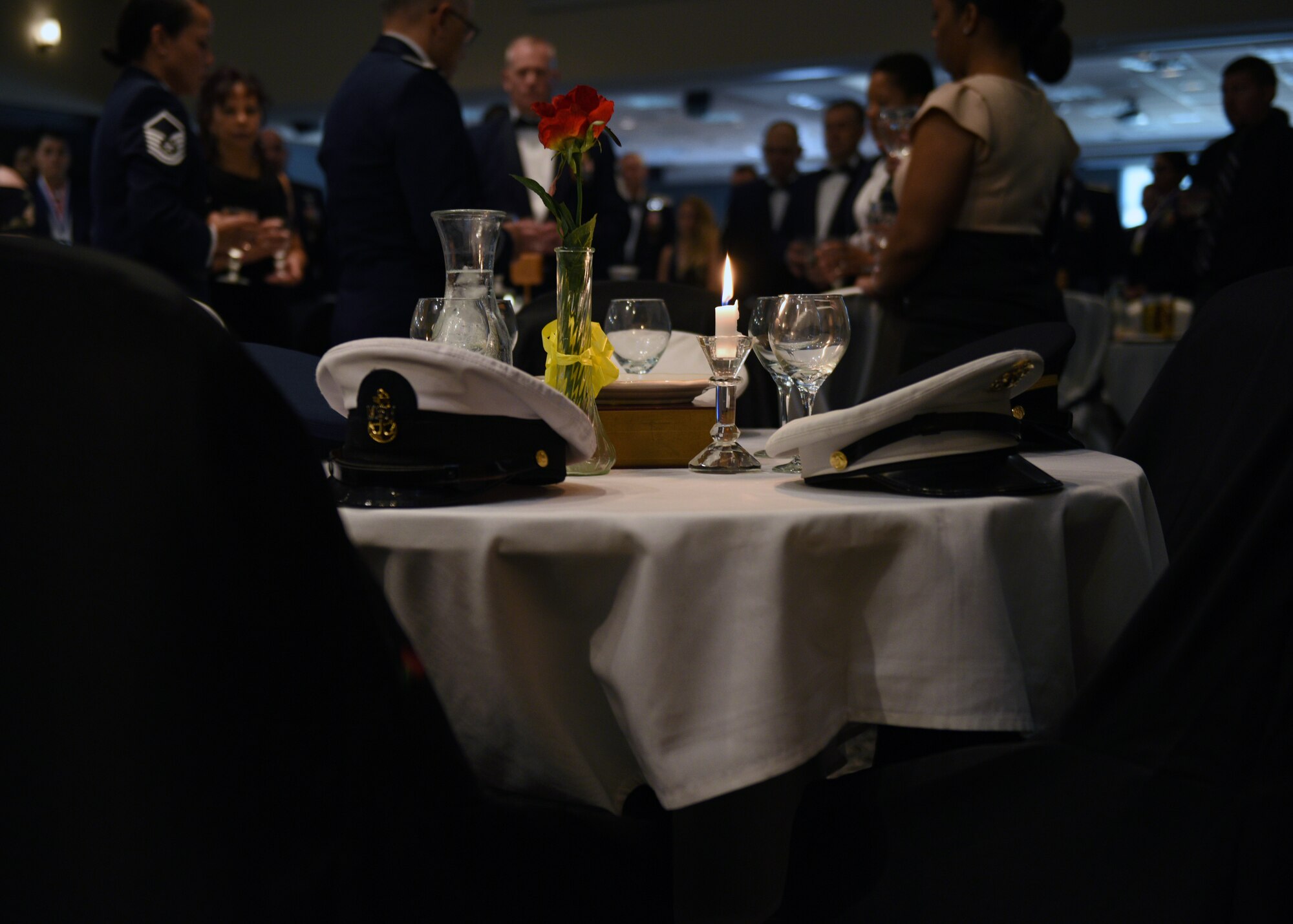 The POW/MIA table is set by the base honor guard during the Senior Noncommissioned Officer Induction Ceremony at the event center on Goodfellow Air Force Base, Texas, August 16, 2019. The table is a symbol to honor and remember America’s prisoners of war and missing comrades across all branches. (U.S. Air Force photo by Airman 1st Class Robyn Hunsinger/Released)