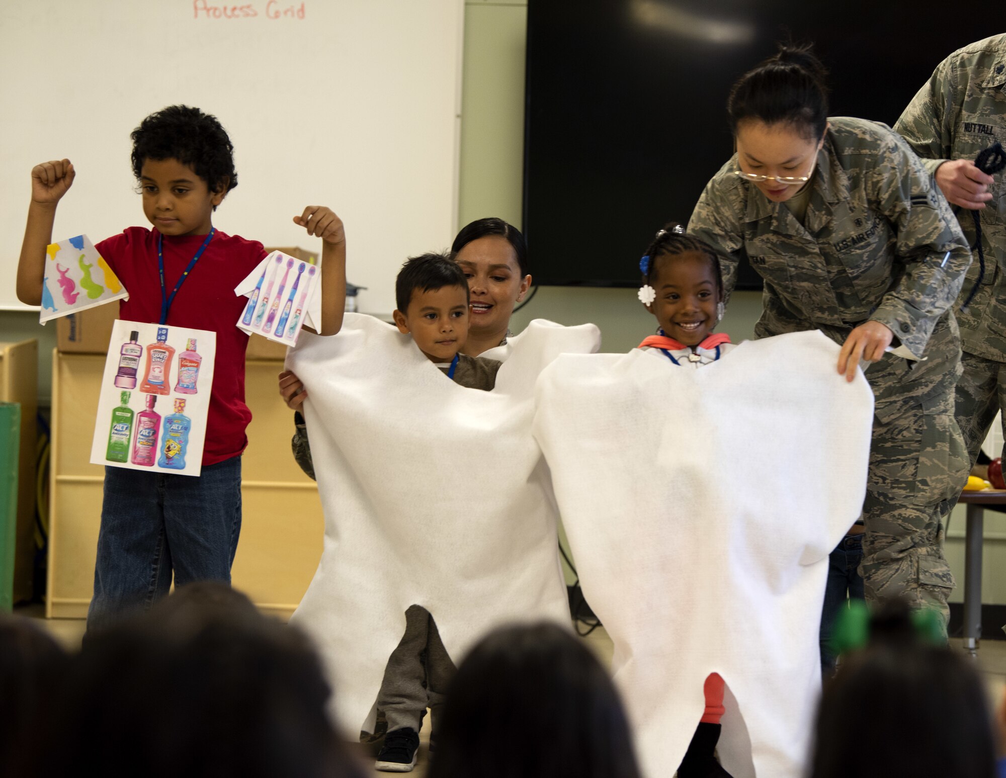 U.S. Air Force Airman 1st Class Yun Tan, 60th Dental Squadron dental assistant, adjusts a tooth costume on a student Feb. 20, 2019, at Mary Bird Elementary School, Fairfield, California. The 60th Dental Squadron visited four schools to educate more than 1300 students on dental health. (U.S. Air Force photo by Airman 1st Class Jonathon Carnell)