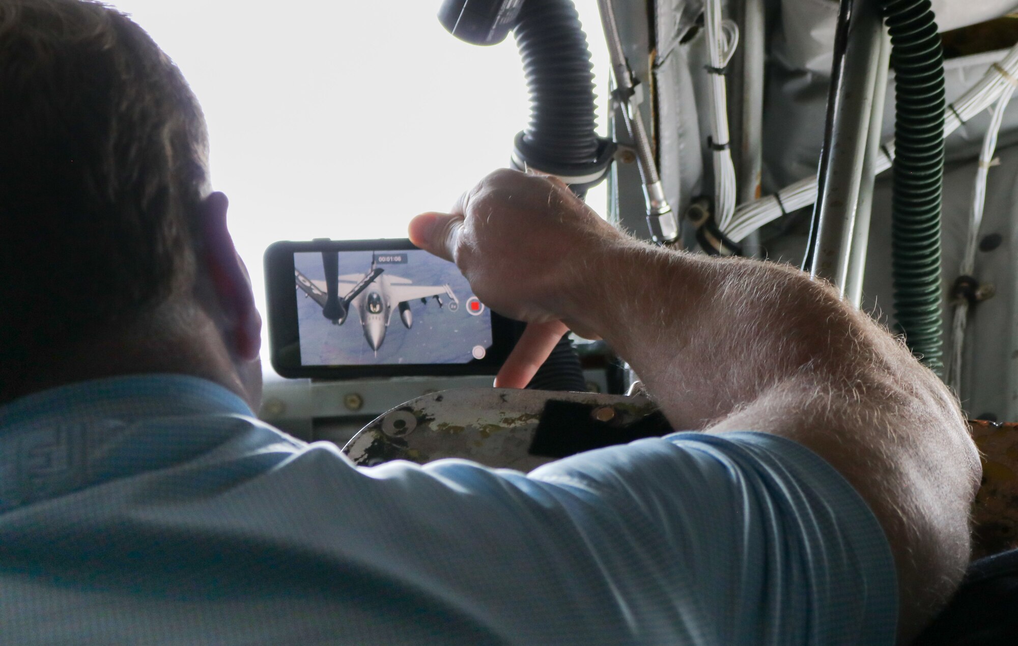 Rep. Kevin Hern snaps a photo of a 138th Fighter Wing F-16 Fighting Falcon preparing to receive fuel from a 507th Air Refueling Wing KC-135R Statotanker during a congressional orientation flight, Aug. 15, 2019, at Tinker Air Force Base, Oklahoma. The Okies shared the Reserve mission and a unique experience with the congressional delegation.(U.S. Air Force photo by Senior Airman Mary Begy)