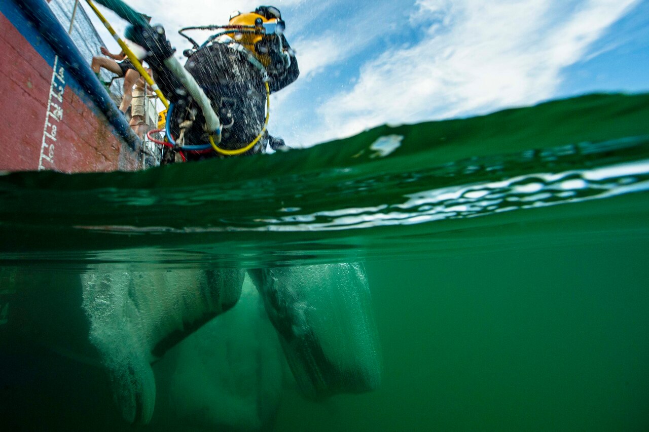 Army diver jumping into the water.
