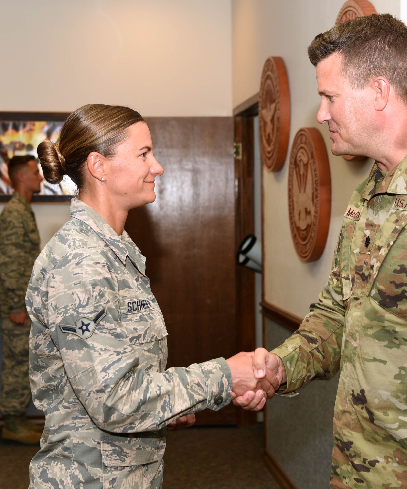 U.S. Air Force Lt. Col. Michael McCourt, 312th Training Squadron commander, congratulates Airman Kristina Schneider, 312th Training Squadron fire protection student during her graduation at the Louis F. Garland Department of Defense Fire Academy on Goodfellow Air Force Base, Texas, August 20, 2019. Schneider successfully finished a 20-day fire suppression course where students learn with a hands on approach to a variety of burning environments, such as vehicle, ground, and building fires. (U.S. Air Force photo by Airman 1st Class Abbey Rieves/Released)