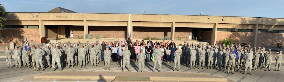 The 17th Medical Group forms in front of the base clinic after the reorganization ceremony at the Ross Clinic on Goodfellow Air Force Base, Texas, August 15, 2019. The reorganization ceremony was to show the re-designation of one squadron and the inactivation and activation of the second squadron. (U.S. Air Force photo by Senior Airman Seraiah Wolf/Released)