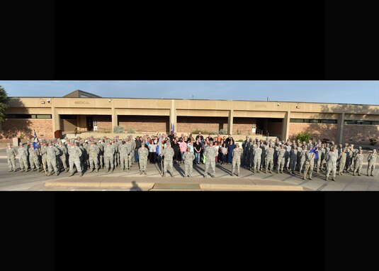 The 17th Medical Group forms in front of the base clinic after the reorganization ceremony at the Ross Clinic on Goodfellow Air Force Base, Texas, August 15, 2019. The reorganization ceremony was to show the re-designation of one squadron and the inactivation and activation of the second squadron. (U.S. Air Force photo by Senior Airman Seraiah Wolf/Released)