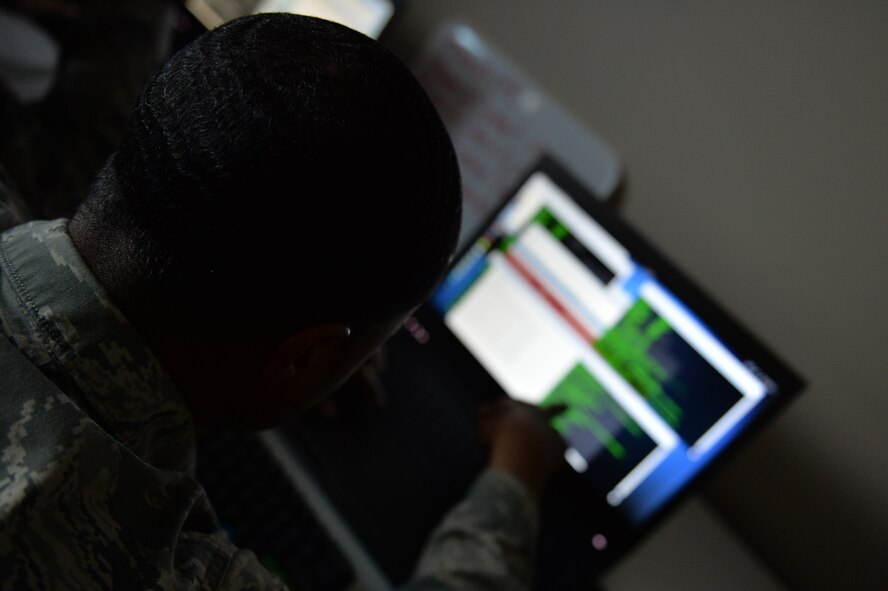 A member of the Mission Defense Team at the 432nd Aircraft Communications Maintenance Squadron explains to his partner how he is responding to a network attack during a cyber-defense training exercise at Creech Air Force Base, Nevada, Dec. 21, 2017. MDTs are the result of the Cyber Squadron Initiative (CS-I), which is a plan to move communications squadrons away from Information Technology (IT) service and toward a mission set that involves the cyberspace side of their wing’s operational mission. (U.S. Air Force photo by Airman 1st Class Haley Stevens)