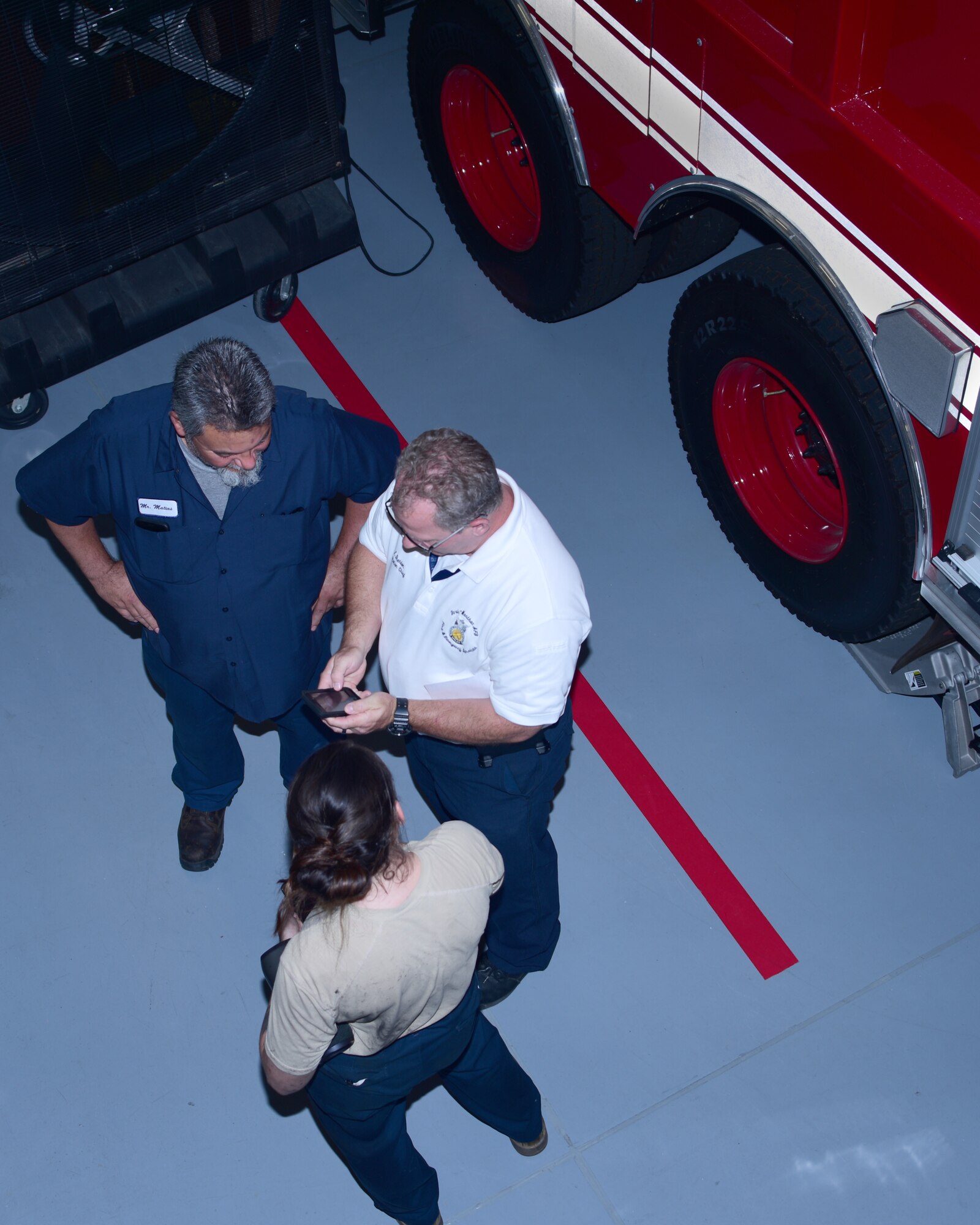 a photo of fire chiefs talking in the fire station
