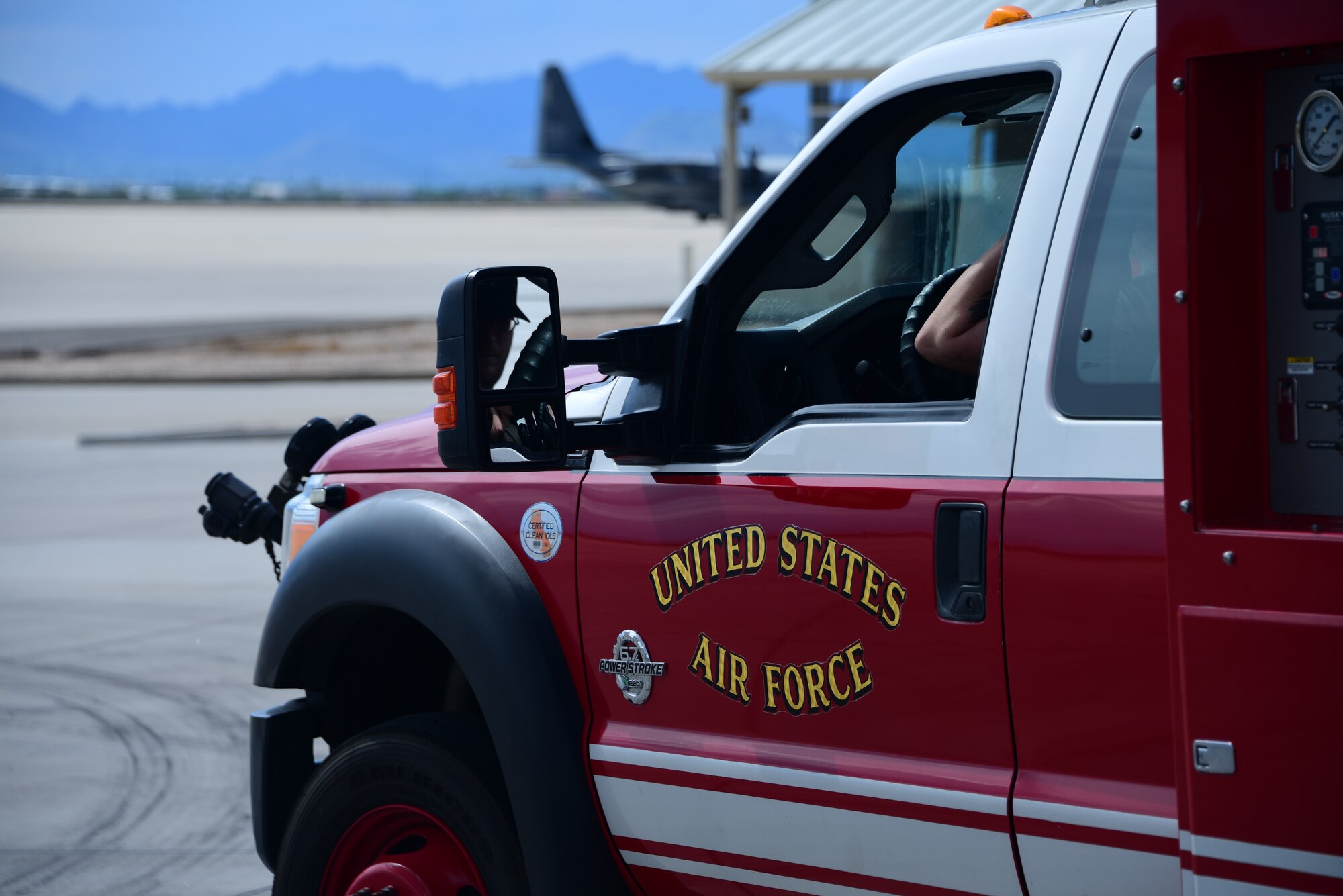 a photo of a fire truck sitting on the flight line