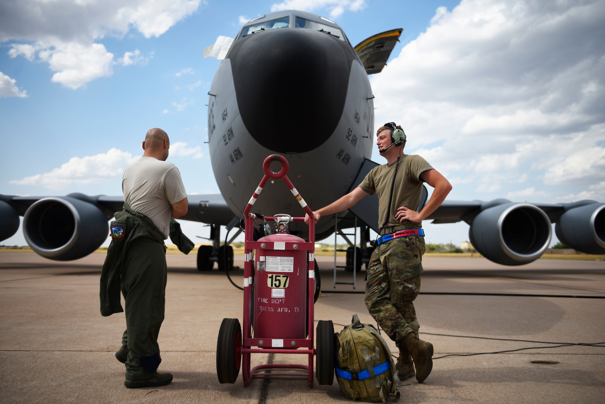U.S. Air Force Tech. Sgt. Norbert Roland (left) and Senior Airman Zachery Murray (right), 92nd Aircraft Maintenance Squadron flying crew chiefs, prepare for pre-flight checks on a KC-135 Stratotanker at Dyess Air Force Base, Texas, Aug. 13, 2019.