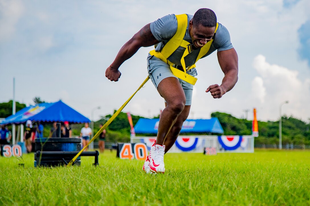 U.S. Marine Corps Staff Sgt. Reginald Berry the chief instructor for the Staff Noncommissioned Officers Academy, pulls a weighted sled in the sled pull event in Okinawa's Strongest Battle of the North, Aug. 18, 2019, Camp Hansen, Okinawa, Japan. The competition challenges men and women to compete in physically demanding events to find the strongest on the island