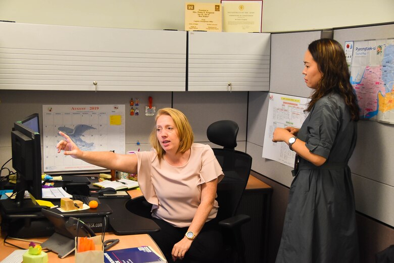 Penny Ferguson (left), a U.S. Army Corps of Engineers (USACE), Far East District (FED) workforce management specialist, speaks with a colleague at Camp Humphreys, South Korea, Aug, 21.