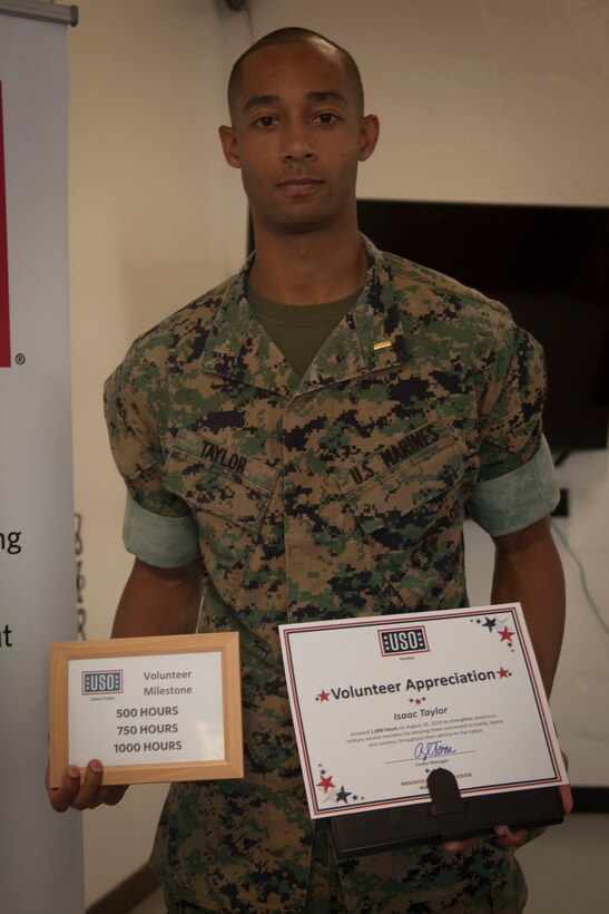 U.S. Marine Corps 2nd Lieutenant Isaac Taylor, 3rd Transportation Support Battalion, Combat Logistics Regiment 3, 3rd Marine Logistic Group, III Marine Expeditionary Force, is awarded the 1000 Volunteer Hours accolade at the United Service Organization Volunteer Recognition at Camp Foster, Okinawa, Japan Aug. 20, 2019.