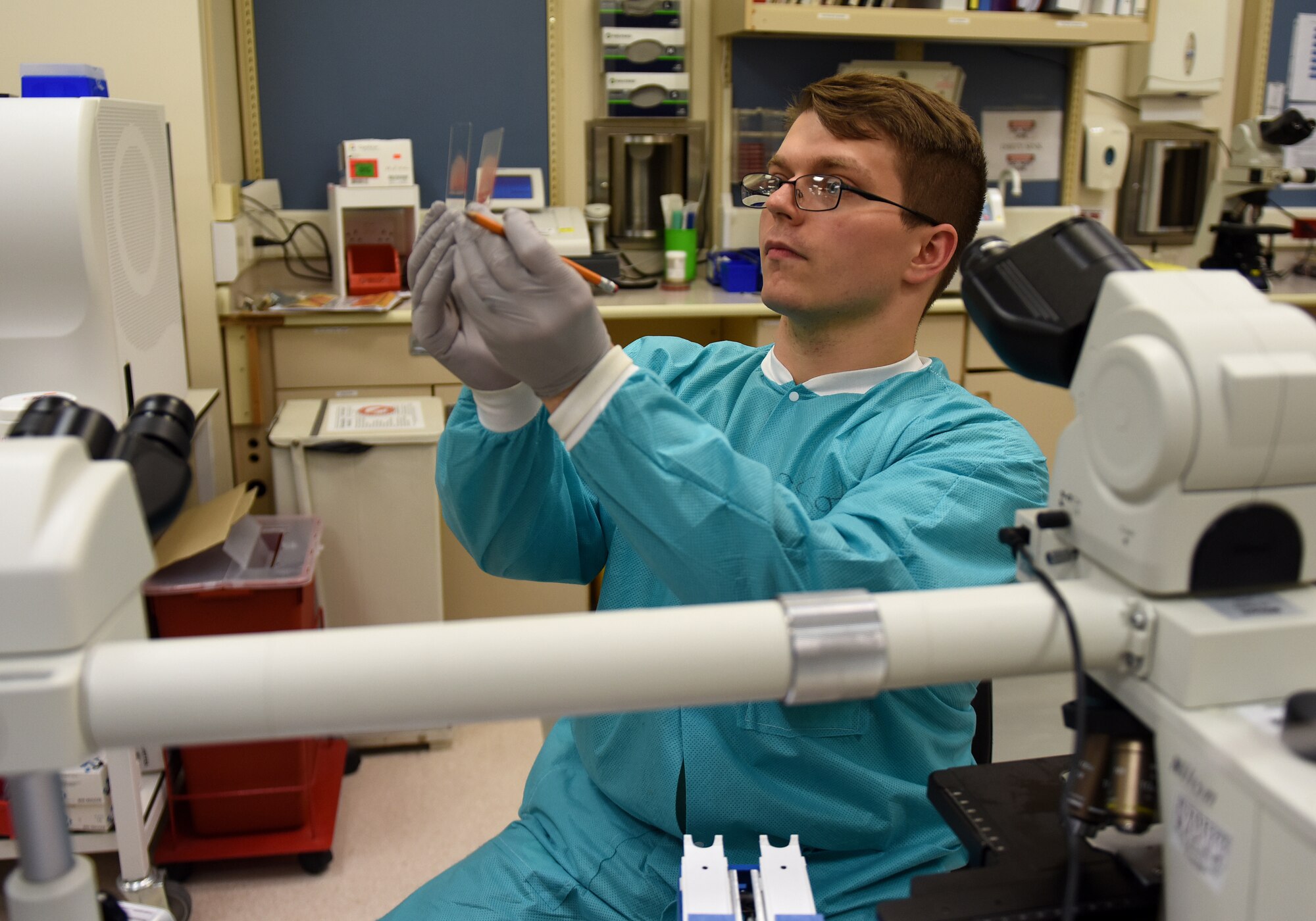 A 48th Medical Support Squadron laboratory technician compares slides at Royal Air Force Lakenheath, England, Aug. 14, 2019. Laboratory technicians provide accurate medical tests and appropriately diagnose illnesses to ensure the readiness of Liberty Wing Airmen. (U.S. Air Force photo by Airman 1st Class Madeline Herzog)