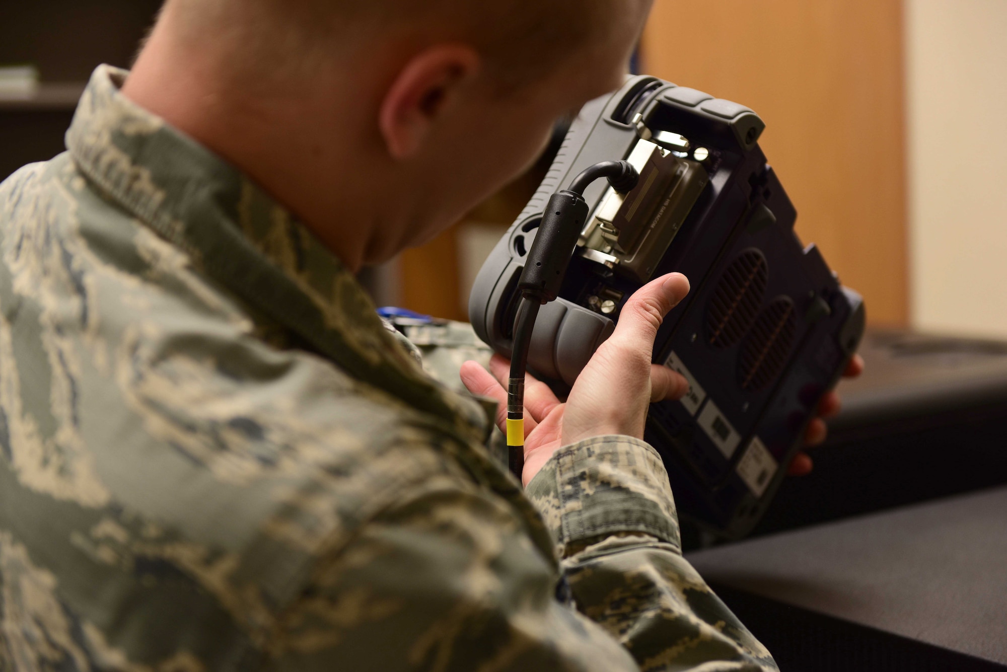 2nd Lt. Eric, 432nd Aircraft Communications Maintenance Squadron Mission Defense Team assistant officer in charge, checks communications equipment at Creech Air Force Base, Nevada, April 29, 2019. To increase the defense of the Remotely Piloted Aircraft cyber network, the Air Combat Command selected the 432nd ACMS at Creech to be the first squadron to test the possibilities of the Cyber Squadron Initiative (CS-I). (U.S. Air Force photo by Airman 1st Class Haley Stevens)