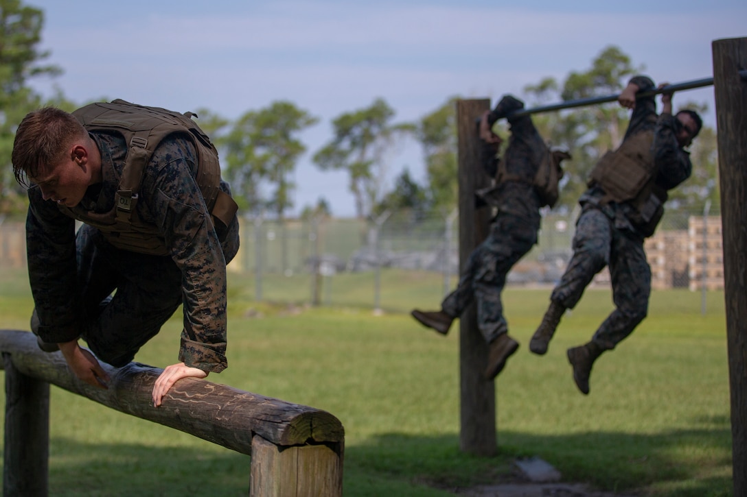 U.S. Marines with 1st Battalion, 10th Marine Regiment, 2nd Marine Division, participate in an obstacle course while performing combat conditioning during a Martial Arts Instructor Course at Camp Lejeune, N.C., Aug. 14, 2019. This three-week long course trains Marines to become Marine Corps Martial Arts Instructors. (U.S. Marine Corps photo by Cpl. Caleb T. Maher)