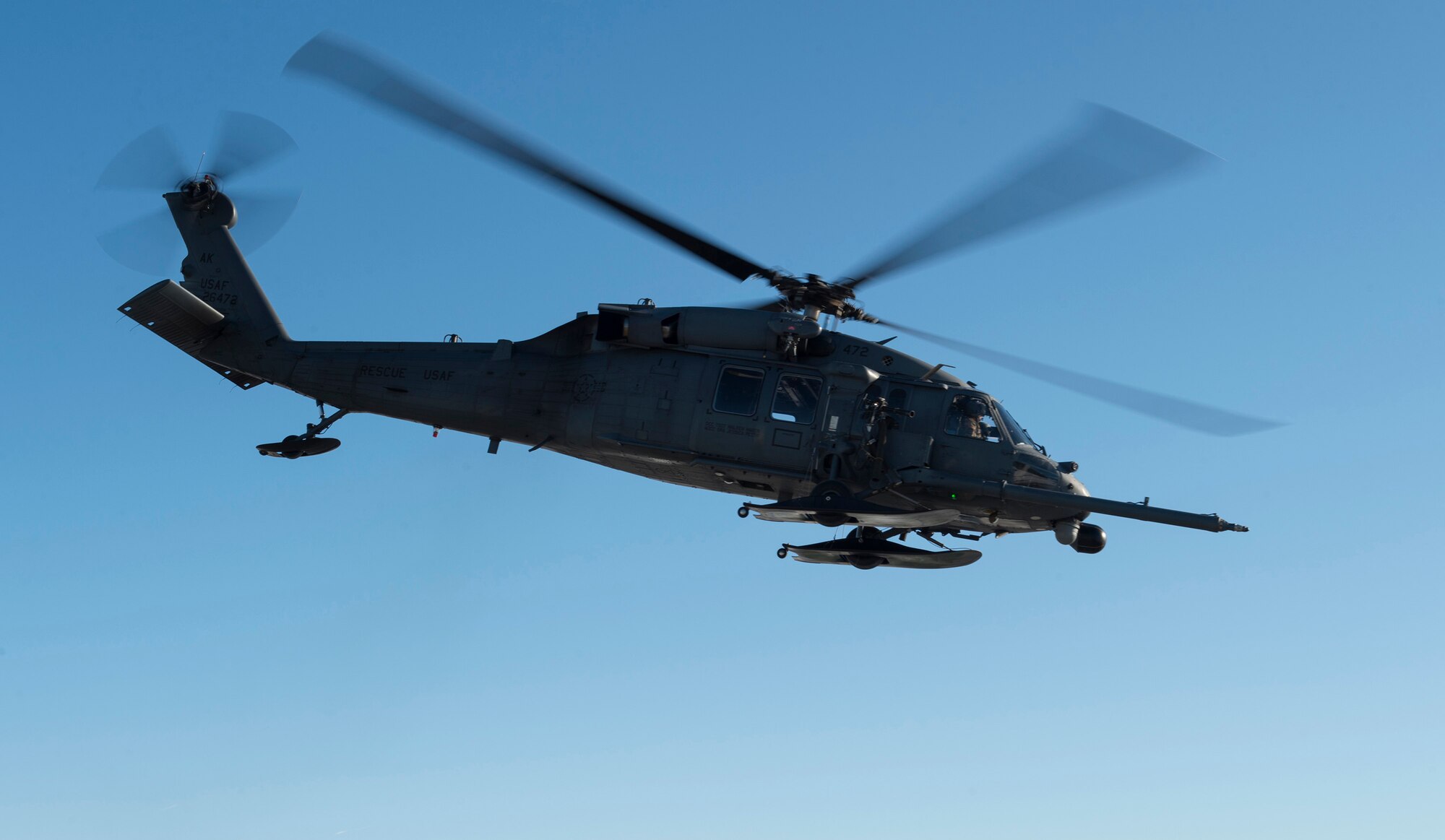 A HH-60G Pave Hawk helicopter operated by Alaska Air National Guardsmen with the 210th Rescue Squadron takes off for aerial live-fire gunnery training at Joint Base Elmendorf-Richardson, Alaska, March 19, 2019. Alaska Air National Guard HH-60G Pave Hawk helicopter special missions aviators honed their aerial gunnery skills by conducting live-fire training with the GAU-2 7.62 mm minigun. (U.S. Air Force photo by Alejandro Peña)