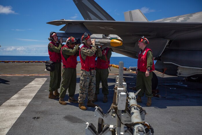 Ordnance Marines with Marine Medium Tiltrotor Squadron 265, 31st Marine Expeditionary Unit, load an AIM- 9X Sidewinder missile onto an F-35B Lightning II fighter aircraft prior to a defensive combat air patrol rehearsal aboard the amphibious assault ship USS Wasp, Pacific Ocean, August 7, 2019. Wasp, flagship of the Wasp Amphibious Ready Group, with embarked 31st MEU, is operating in the Indo-Pacific region to enhance interoperability with partners and serve as ready-response force for any type of contingency, while simultaneously providing a flexible and lethal crisis response force ready to perform a wide range of military operations.